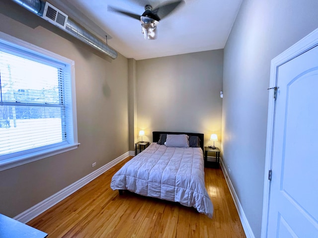 bedroom with ceiling fan and wood-type flooring