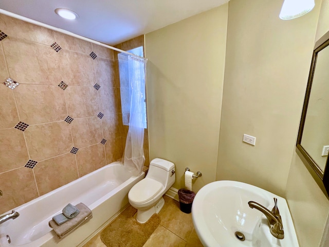 full bathroom with tile patterned floors, toilet, shower / bathtub combination with curtain, and sink