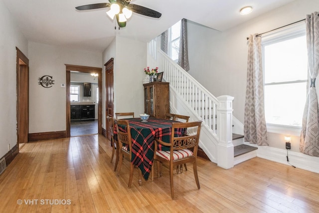 dining room with ceiling fan, a healthy amount of sunlight, and light wood-type flooring