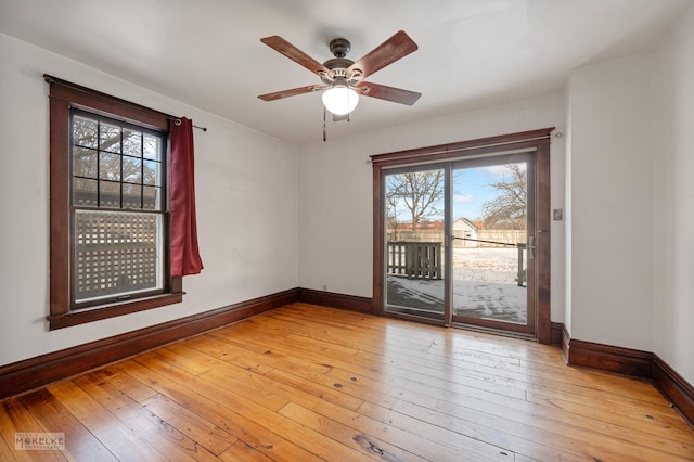 unfurnished room with ceiling fan, a wealth of natural light, and light hardwood / wood-style flooring