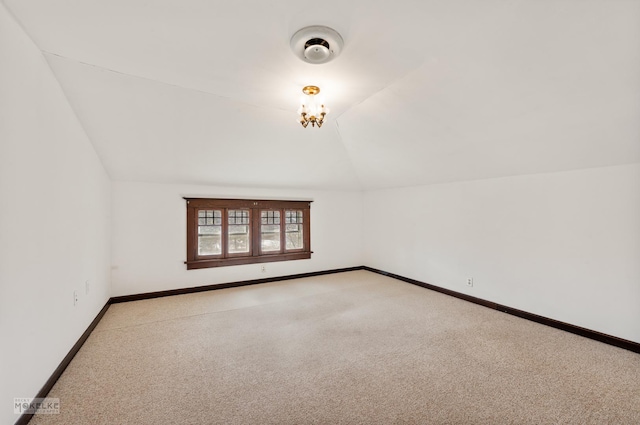 additional living space featuring light colored carpet and vaulted ceiling