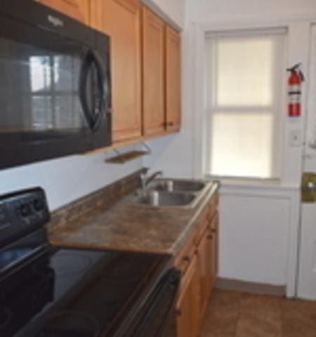 kitchen with sink and black appliances