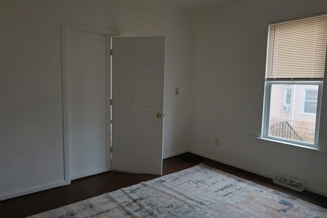 unfurnished bedroom with dark hardwood / wood-style floors