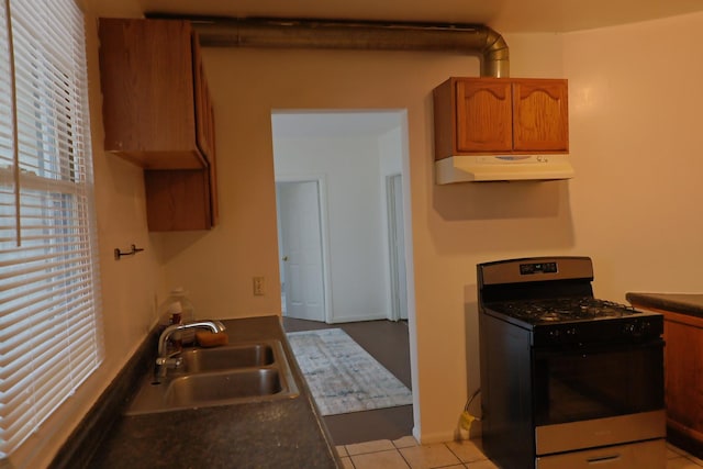 kitchen with sink, light tile patterned floors, and black gas range oven