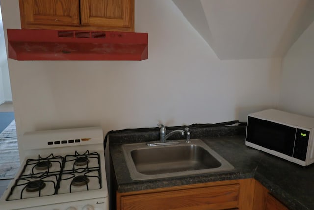 kitchen with range hood, white range with gas cooktop, and sink