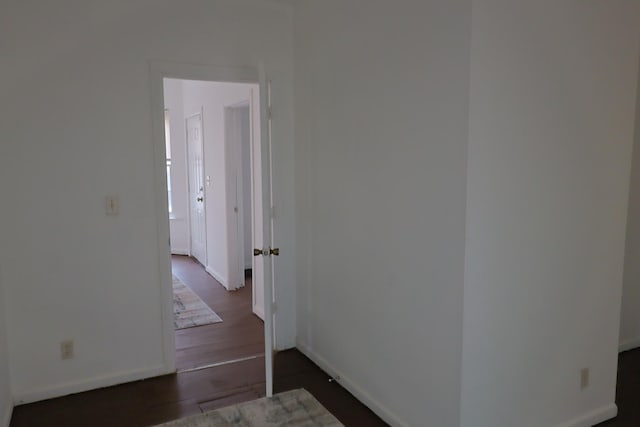 hallway with dark hardwood / wood-style flooring