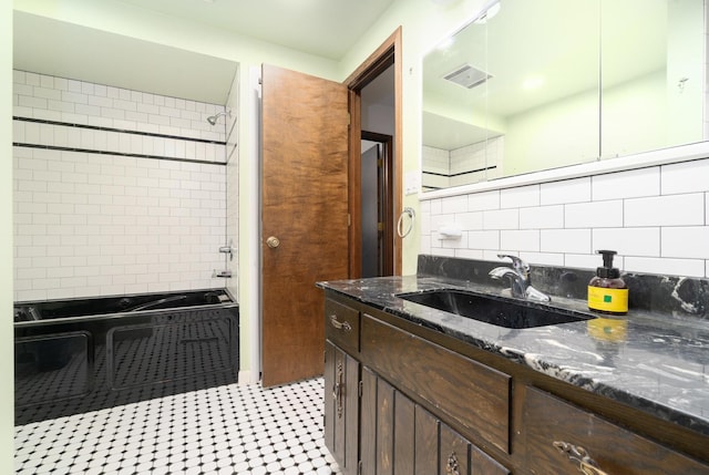 bathroom with vanity and tiled shower / bath