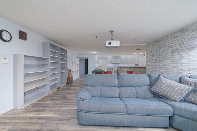 living room with a textured ceiling and light hardwood / wood-style flooring