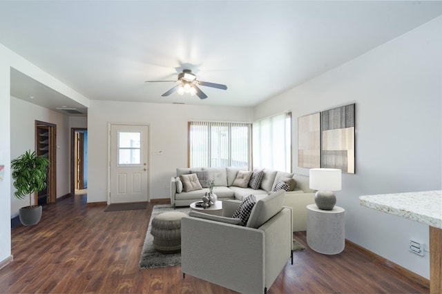 living room featuring ceiling fan and dark wood-type flooring