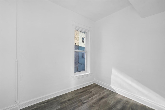 empty room with dark hardwood / wood-style flooring