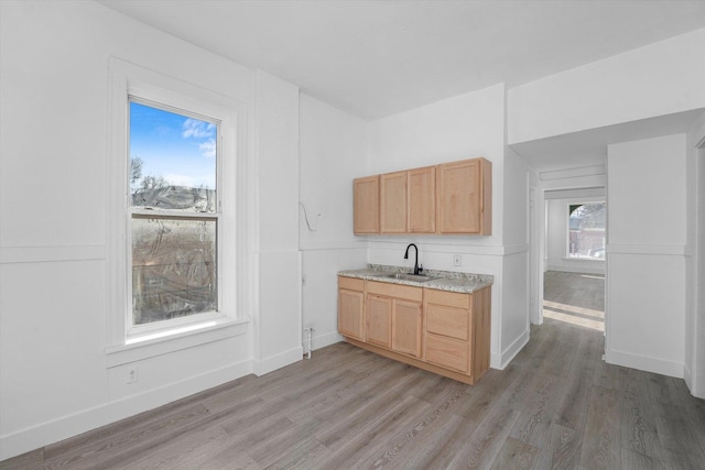 kitchen featuring sink, light hardwood / wood-style flooring, and light brown cabinetry