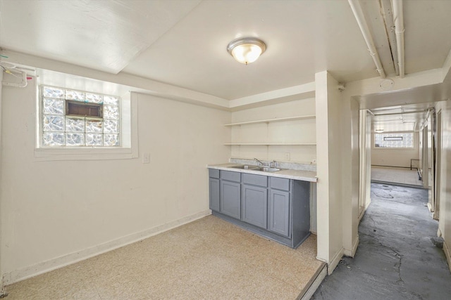 kitchen with sink, a wealth of natural light, and gray cabinets