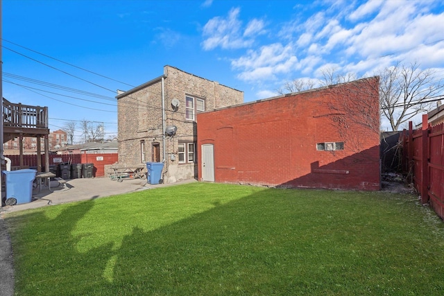 back of house featuring a patio and a lawn