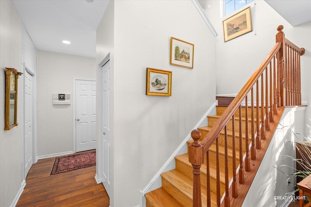 staircase featuring wood-type flooring