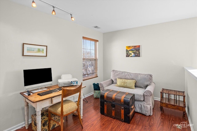 home office featuring dark hardwood / wood-style flooring and track lighting