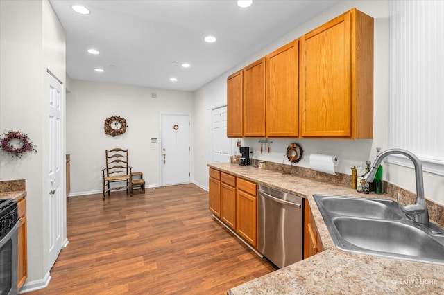 kitchen with dark hardwood / wood-style flooring, stainless steel appliances, and sink