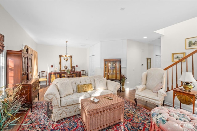 living room with hardwood / wood-style floors and a notable chandelier