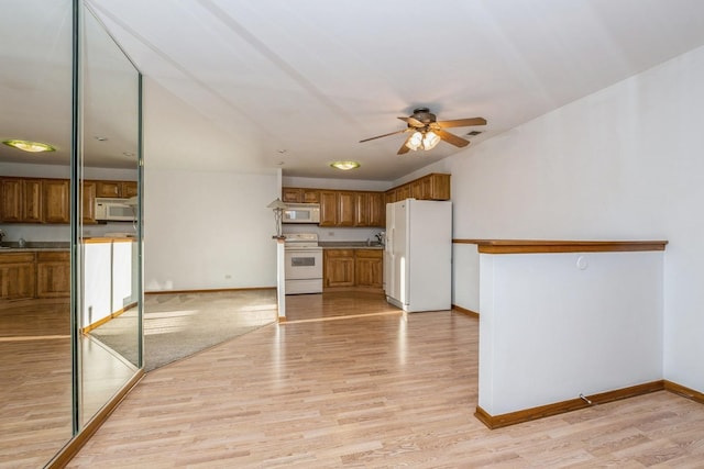 kitchen featuring white appliances, ceiling fan, and light hardwood / wood-style flooring