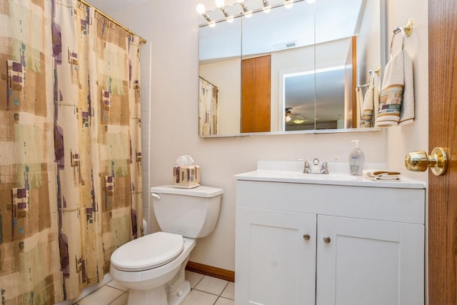 bathroom featuring toilet, vanity, tile patterned floors, and curtained shower