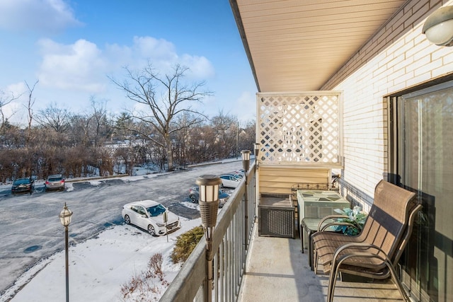 view of snow covered back of property