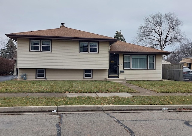 tri-level home featuring a front lawn