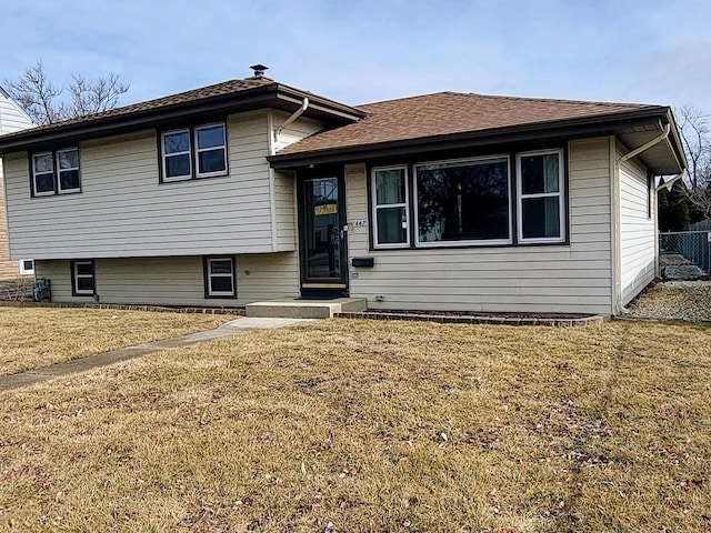 tri-level home with a front yard