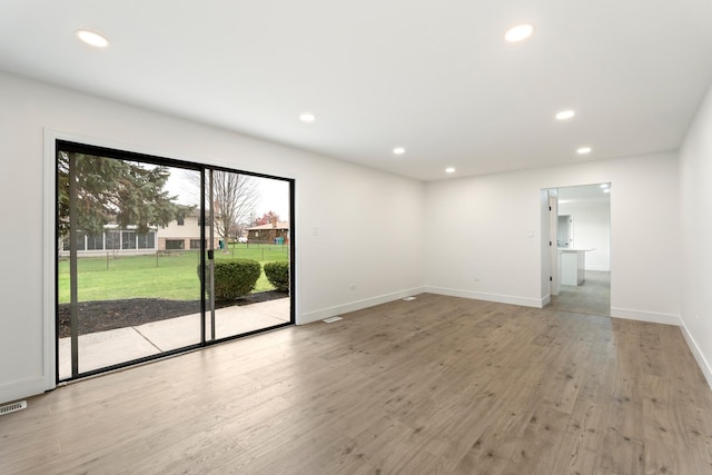 unfurnished room with light hardwood / wood-style floors