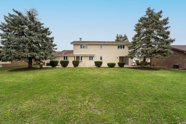 back of property featuring a lawn