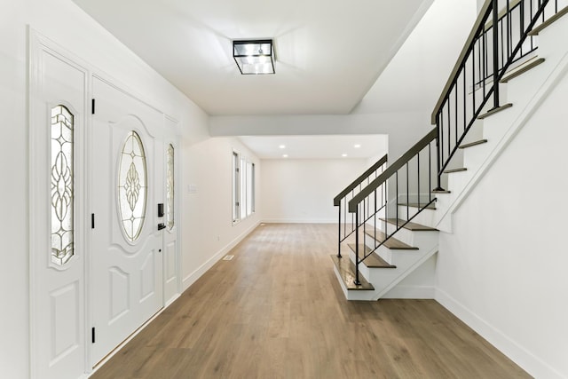 foyer entrance with hardwood / wood-style flooring