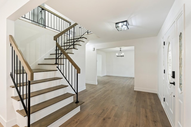 interior space featuring hardwood / wood-style flooring and an inviting chandelier