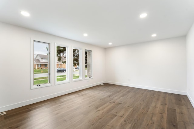 unfurnished room with wood-type flooring