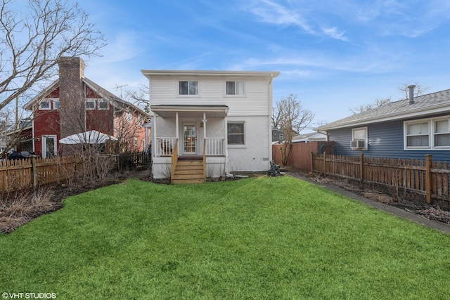 rear view of property featuring a yard