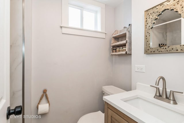 bathroom with vanity and toilet