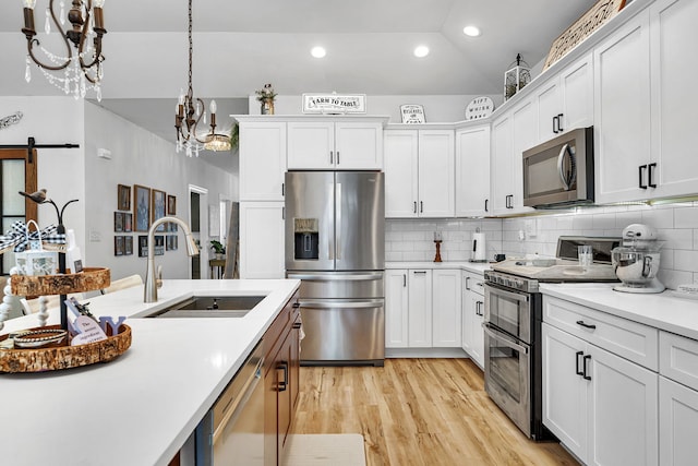 kitchen with sink, stainless steel appliances, and white cabinetry