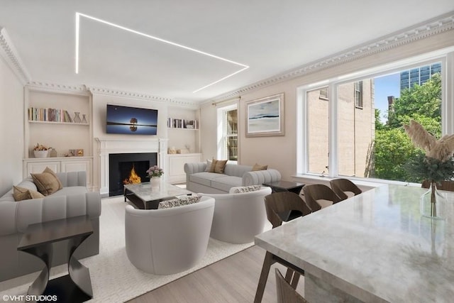 living room featuring light hardwood / wood-style flooring, built in features, and ornamental molding