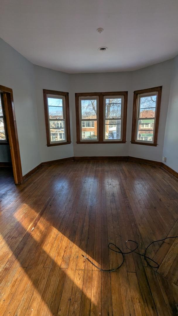 spare room with wood-type flooring