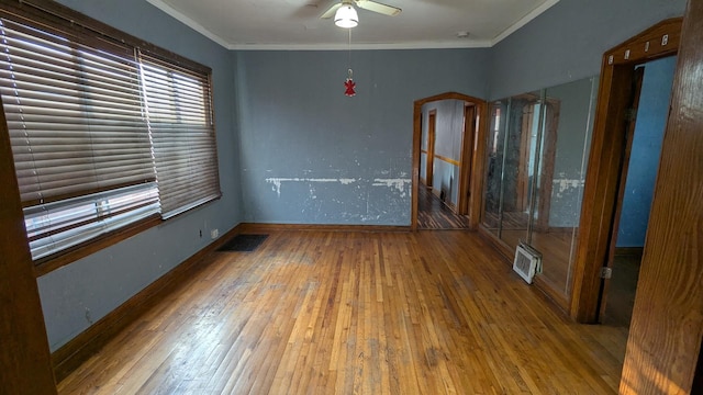 spare room with ceiling fan, crown molding, and hardwood / wood-style floors