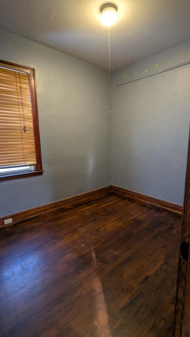 empty room with dark wood-type flooring