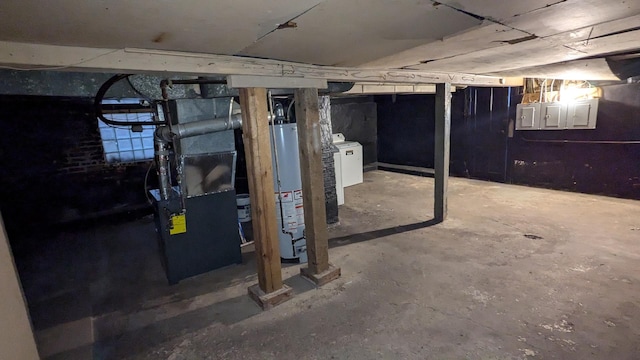 basement with water heater, washer / dryer, electric panel, and heating unit