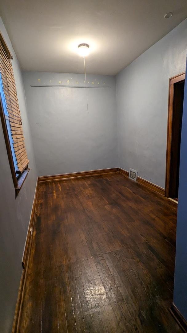 unfurnished room featuring dark wood-type flooring