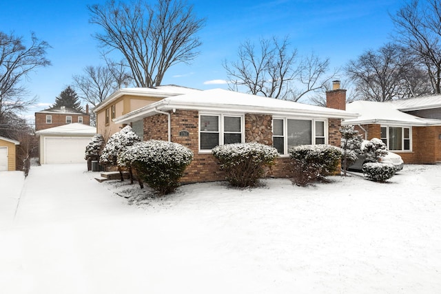 view of front of house with a garage and an outdoor structure