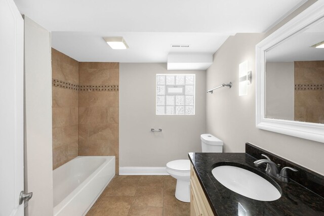 full bathroom featuring tile patterned flooring, vanity, toilet, and tiled shower / bath combo