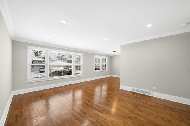 unfurnished living room with hardwood / wood-style floors and ornamental molding