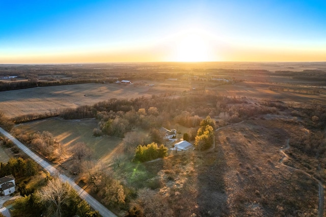 aerial view at dusk featuring a rural view