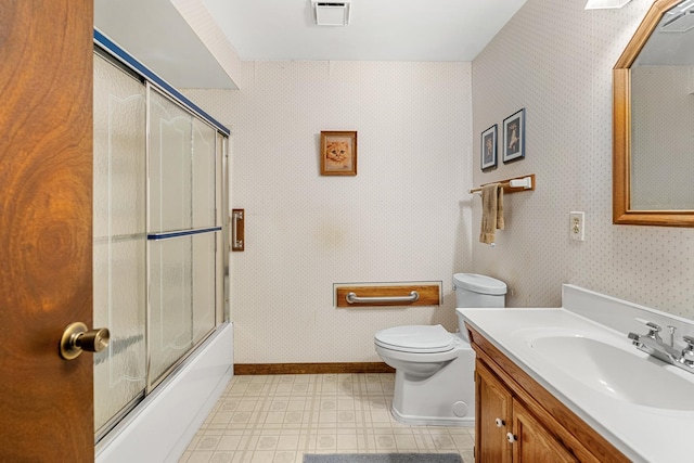 full bathroom with combined bath / shower with glass door, vanity, and toilet