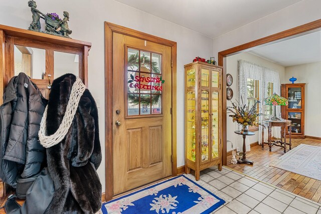 laundry area featuring hardwood / wood-style flooring, cabinets, and washing machine and clothes dryer