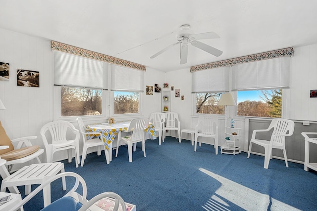 playroom with ceiling fan and dark colored carpet