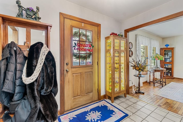 doorway featuring light tile patterned floors and a healthy amount of sunlight