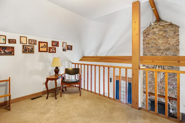 living area featuring carpet floors and vaulted ceiling with beams