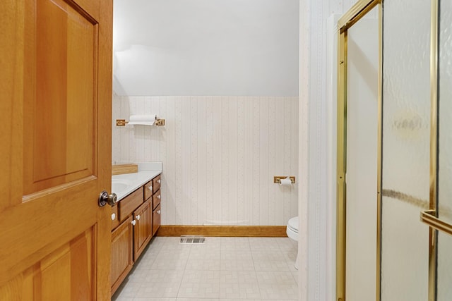 bathroom with an enclosed shower, vanity, and toilet